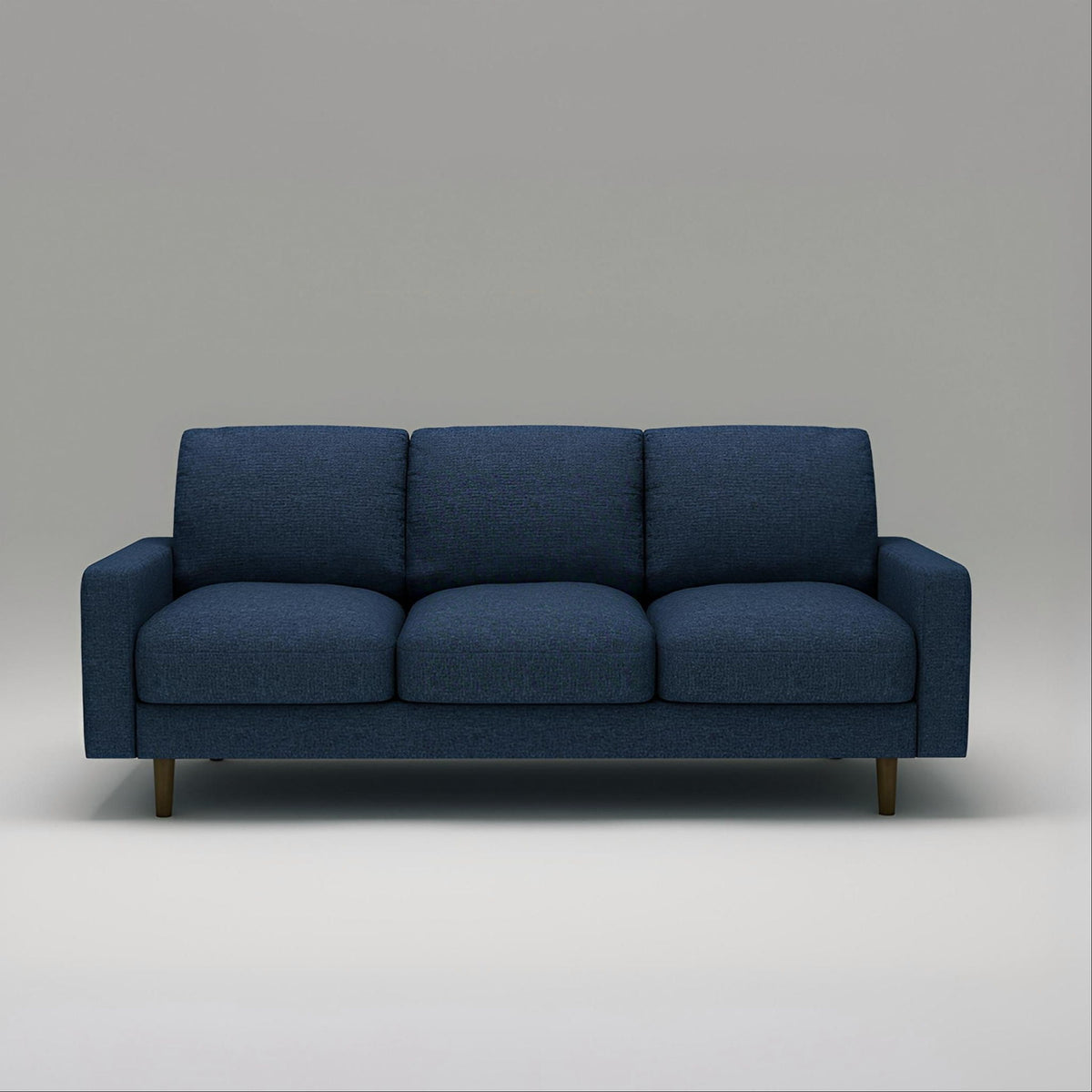 Dark blue US Pride 3 seater sofa with loose back cushions and accent pillows for a modern living room.