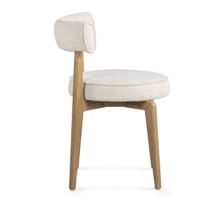 Cream fabric side dining chair by TOV Furniture with sleek design and plush upholstery, ideal for modern dining spaces.