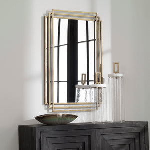 Uttermost Amherst wall mirror with a sleek, modern frame hanging on a wall, showcasing contemporary home decor style.