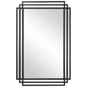Uttermost Amherst wall mirror with a sleek, modern frame hanging on a wall, showcasing its stylish design and reflective surface.