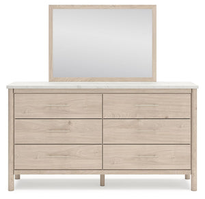 Signature Design by Ashley Cadmori six drawer dresser with a dark wood finish and modern hardware, showing the front view.