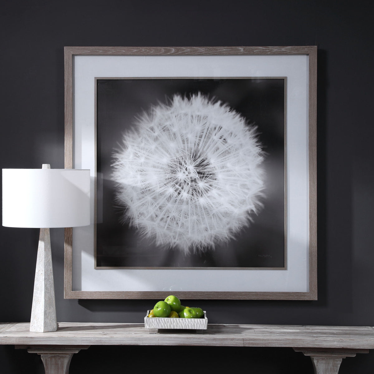 Framed print of a dandelion seedhead in black from Uttermost, showcasing delicate seed details on a neutral background.