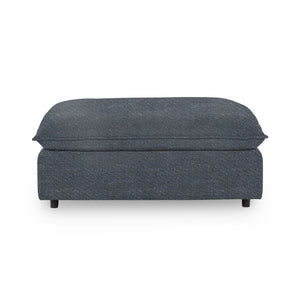 Classic Home Caplan upholstered ottoman with a cushioned top and wooden legs, ideal for living room or bedroom decor.