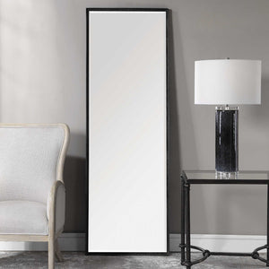 Uttermost Callan Leaner Mirror in black with sleek modern frame, standing tall against a neutral background.