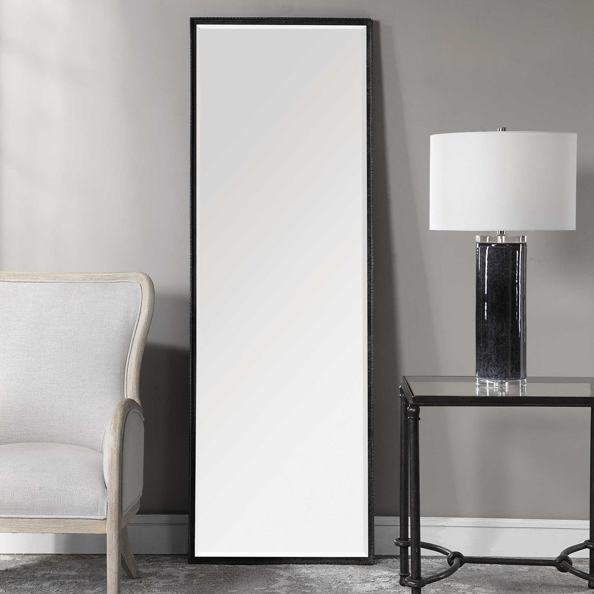 Uttermost Callan Leaner Mirror in black with sleek modern frame, standing tall against a neutral background.