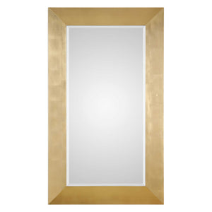 Uttermost Chaney gold wall mirror with a sleek, modern frame, mounted on a wall for stylish home decor.