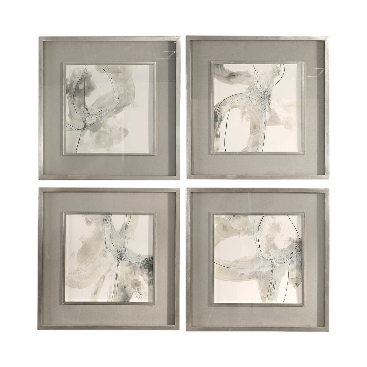Set of four beige abstract art framed prints by Uttermost, featuring modern, minimalist designs for stylish wall decor.
