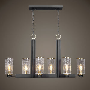 Uttermost Jarsdel 6-light industrial island pendant light in black with metal jar-shaped shades over kitchen island.