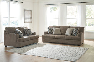 Three-piece living room set by Signature Design Ashley featuring a sofa, loveseat, and armchair with neutral upholstery.