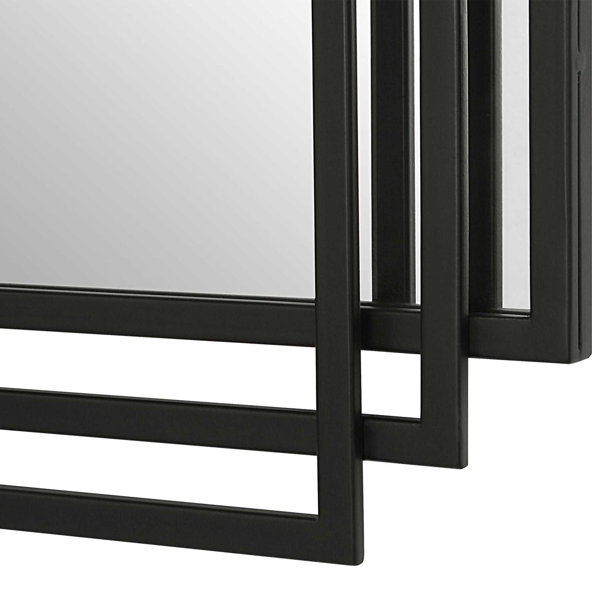 Uttermost Amherst wall mirror with a sleek, modern frame, hanging on a wall in a contemporary interior.