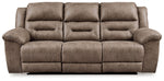 Signature Design by Ashley reclining sofa from Stoneland collection, featuring plush cushions and a comfortable reclining design.