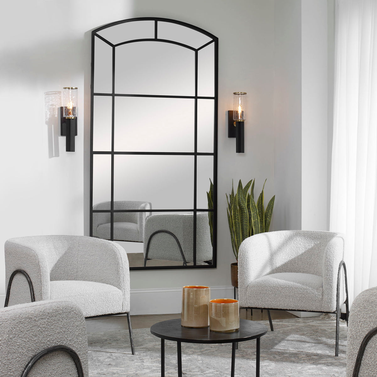 Black oversized arch accent mirror by Uttermost, featuring a sleek, modern design with a bold black frame.