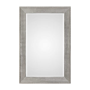 Silver metallic wall mirror with a sleek, modern frame from Uttermost Leiston collection, reflecting light and adding contemporary style.