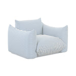 TOV Furniture Saint Tropez outdoor armchair with plush stuffed cushions, beige fabric, and sturdy wooden legs for patio relaxation.