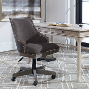 Aidrian charcoal desk chair by Uttermost featuring a modern design with upholstered seat and backrest on sleek metal legs.