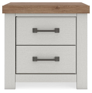 Benchcraft Savonport two-drawer nightstand with charging station in white and brown, featuring a modern design and functional storage.