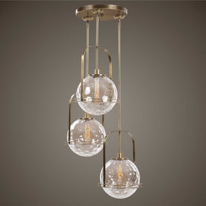 Uttermost Mimas 3-Light Cluster Pendant in gold with modern pendant lighting design, hanging with visible cords and three light fixtures.