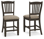 Set of two Signature Design by Ashley Tyler Creek upholstered barstools with black and grayish brown fabric, featuring padded seats and backrests.