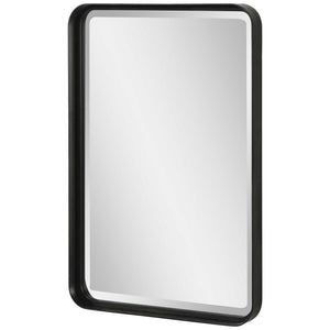 Uttermost Croften black vanity mirror with a sleek rectangular frame, reflecting a modern bathroom or dressing area.