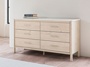 Signature Design by Ashley Cadmori six-drawer dresser with wood finish and modern style, featuring sleek metal handles.
