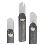 Set of three Uttermost Karter iron and glass candleholders in pearl silver and dark gray, featuring sleek modern design.