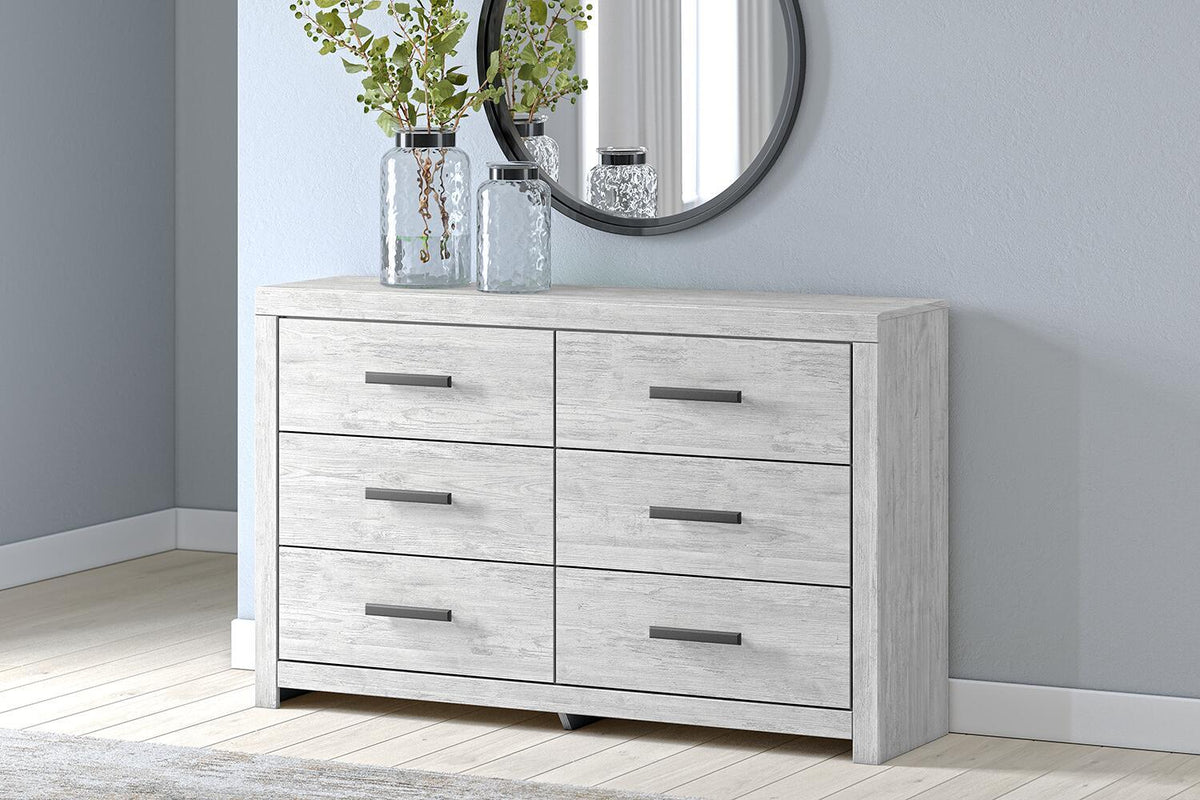 Whitewashed Cayboni dresser with six drawers by Signature Design by Ashley, featuring sleek modern design and silver handles.