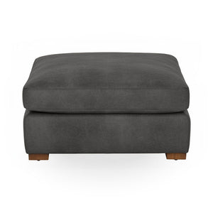 Classic Home Audrey upholstered ottoman with a cushioned, fabric-covered top and wooden legs, versatile for living room decor.