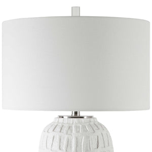 Uttermost Caelina textured white table lamp with a modern design, featuring a cylindrical base and a fabric shade.