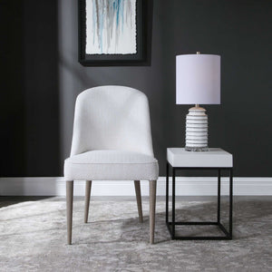 Pair of armless chairs from Uttermost's Brie chair set, featuring sleek design and neutral upholstery.