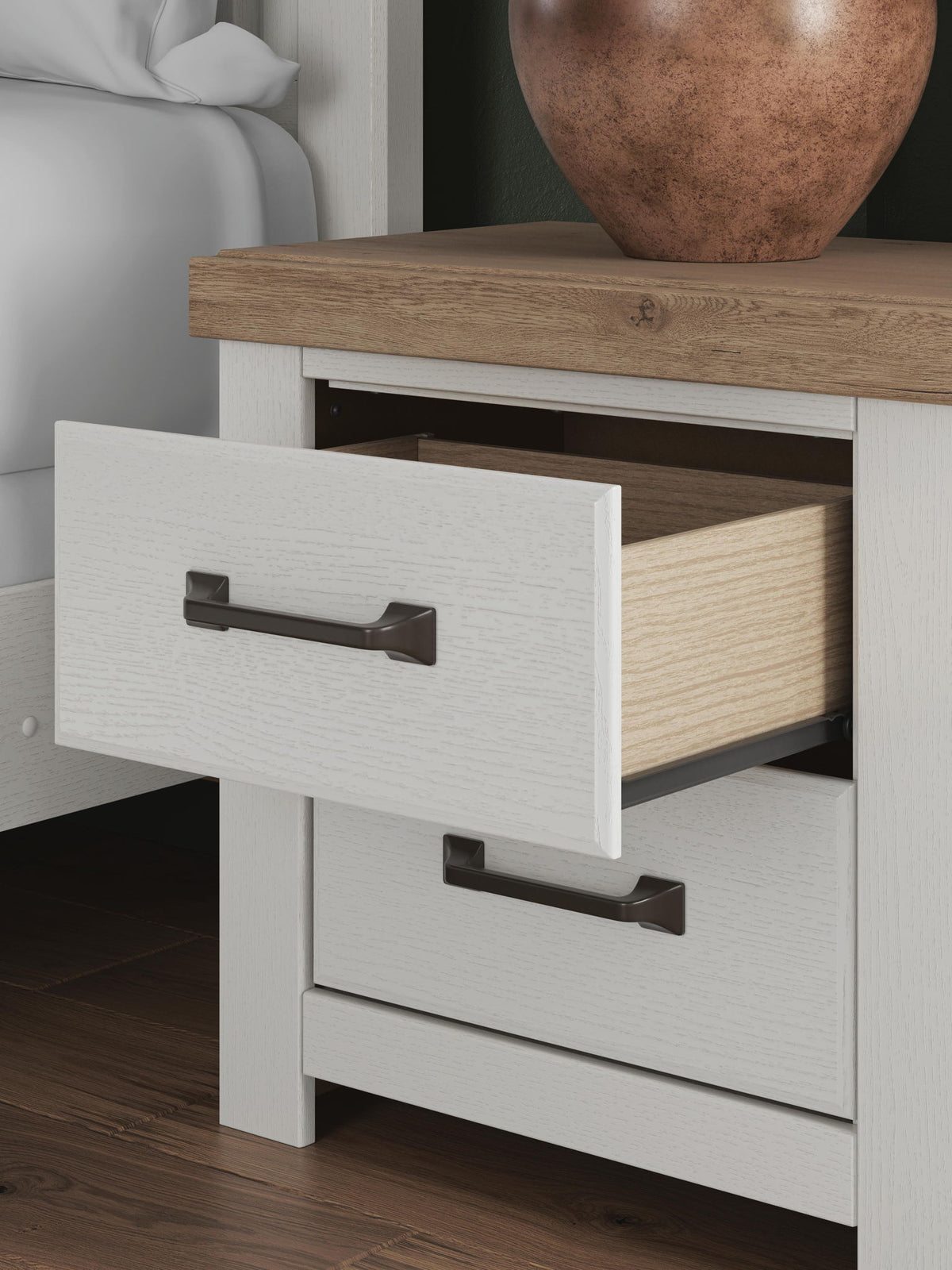 Benchcraft white and brown two-drawer nightstand with charging station, modern design, featuring sleek drawers and a sturdy build.