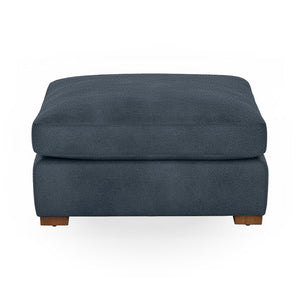 Classic Home Audrey upholstered ottoman with cushioned top and wooden legs, ideal as a versatile living room accent piece.