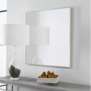 Uttermost Alexo square wall mirror with a sleek frame, reflecting interior decor and natural light.