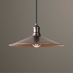 Uttermost Barnstead 1-light copper pendant lighting with light brown finish, hanging from a ceiling with a warm, inviting glow.
