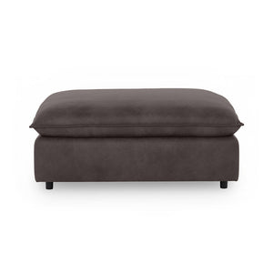 Classic Home Caplan upholstered ottoman with a plush fabric surface and wooden legs, perfect as a footrest or accent piece.