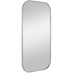 Uttermost Taft wall mirror with a sleek, modern frame, hanging on a wall, reflecting a stylish interior space.