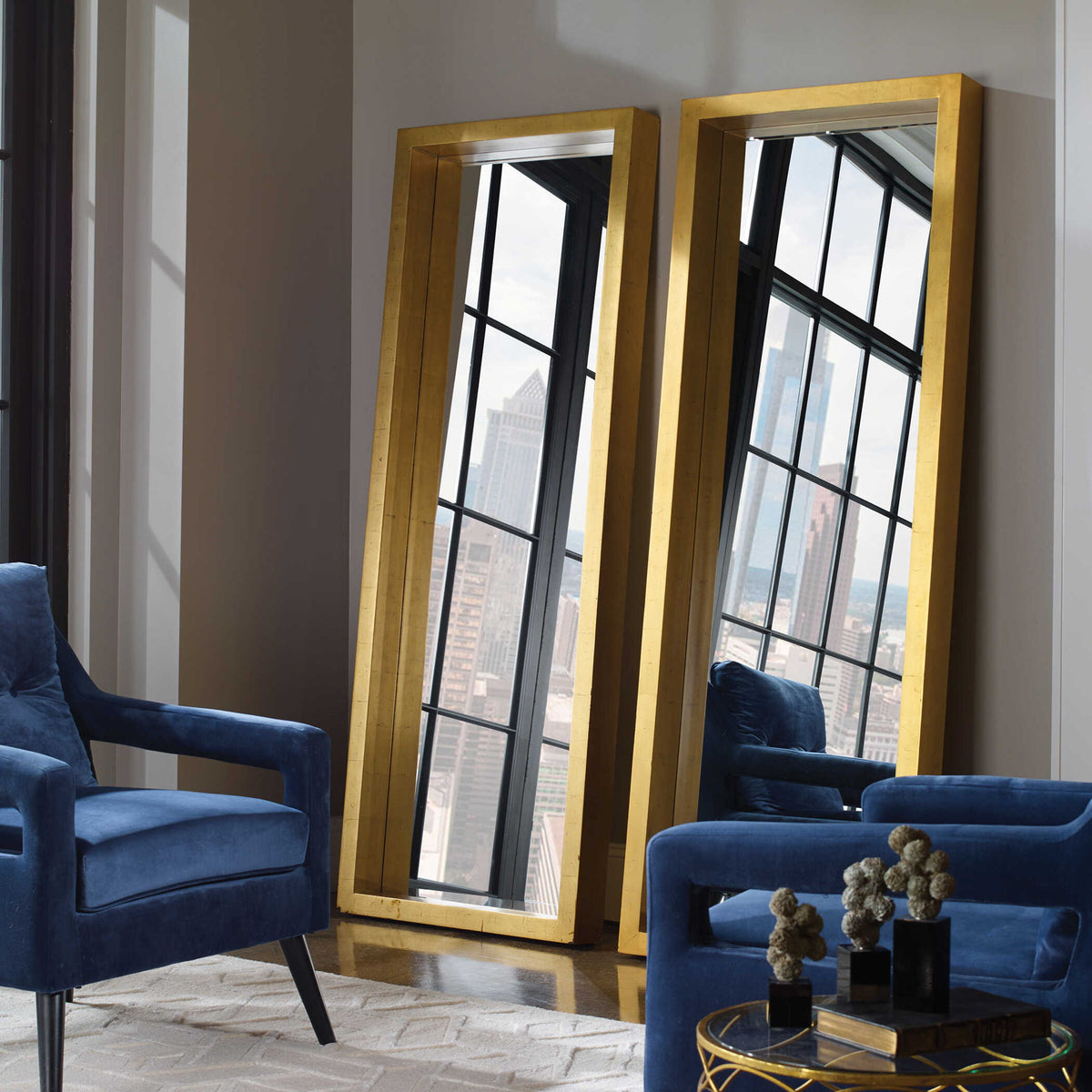 Gold Edmonton Leaner Floor Mirror by Uttermost with a sleek, modern frame reflecting in a stylish interior setting.