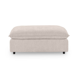 Classic Home Caplan upholstered ottoman with a plush fabric cover and sturdy wooden legs, perfect as a versatile footrest or accent piece.