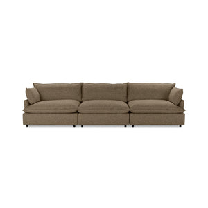 Classic Home Caplan modular sectional in neutral fabric, showing its L-shaped design with plush cushions and wooden legs.
