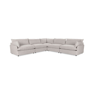 Classic Home Caplan modular sectional sofa with beige upholstery and plush cushions in a modern living room setting.
