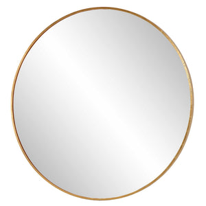Uttermost Junius round wall mirror with a sleek frame, hanging on a wall, reflecting a modern interior.