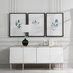 Set of three framed watercolor sage green prints by Uttermost, featuring simple botanical designs on white backgrounds.