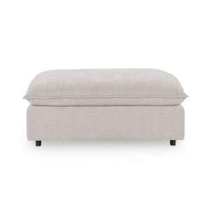 Classic Home Caplan upholstered ottoman with a cushioned top and wooden legs, ideal for living room or bedroom decor.