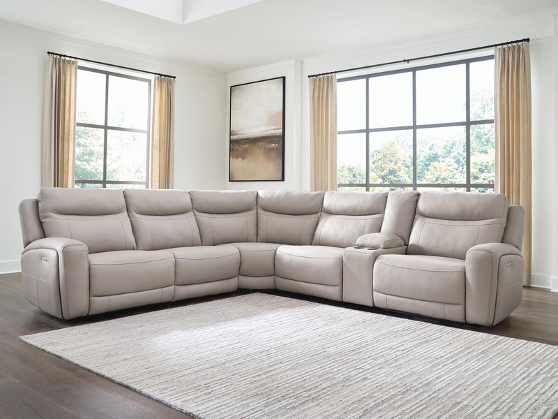 Benchcraft® Gravier reclining sectional with plush cushions and reclining seats, shown in a modern living room setting.