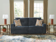 Signature Design by Ashley Danum 2-seat reclining sofa with plush cushions and reclining features in a modern living room setting.