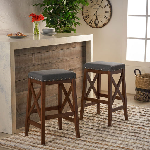 Set of two Noble House upholstered bar stools with nailhead trim and X frame design in charcoal fabric.