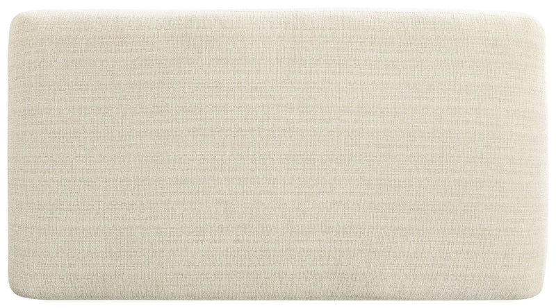 Upholstered Maggie ottoman by Signature Design by Ashley, featuring a soft fabric surface and sturdy wooden legs.