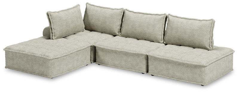 Signature Design by Ashley stationary sectional sofa with plush cushions and modern design, shown in a living room setting.