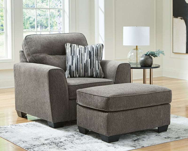 Benchcraft Olten living room set with stationary chair and matching ottoman, featuring plush cushions and modern design.
