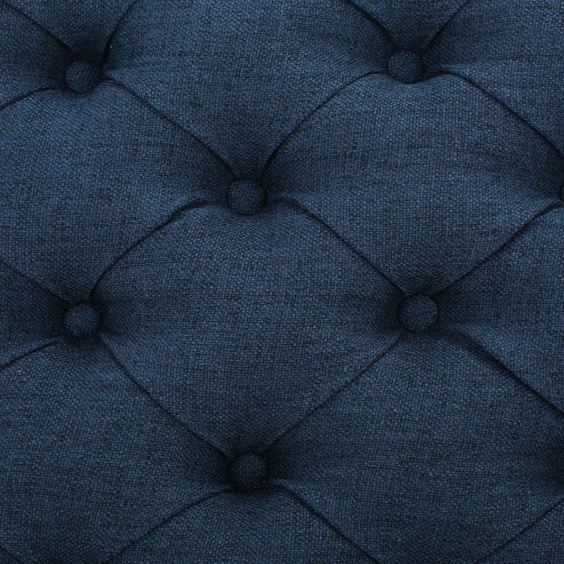 Noble House Guernsey storage ottoman with tufted top and fabric upholstery, serving as a stylish and functional storage solution.