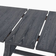 Rustic gray Devingo extendable dining table by Noble House, showing the tabletop with extension leaf and sturdy wooden legs.